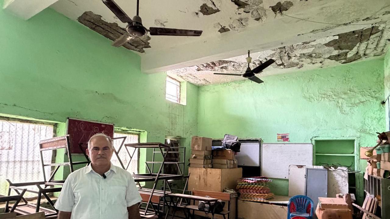 Satpal Narwat, a social worker in Faridabad, stands in a dilapidated classroom  