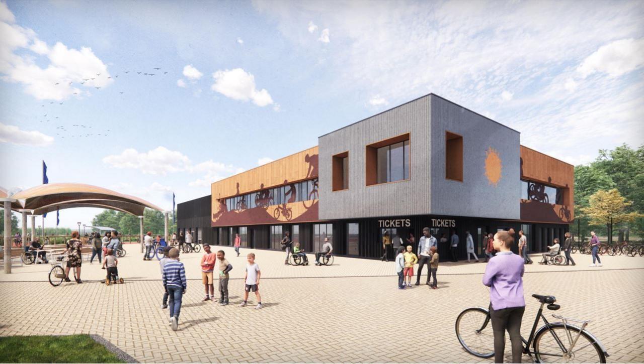 A CGI of how the Bristol Regional Cycling Hub in Lawrence Weston would look. You can see the entrance to the hub. It's a modern building made of wood panelling and the bottom part says 'tickets'.