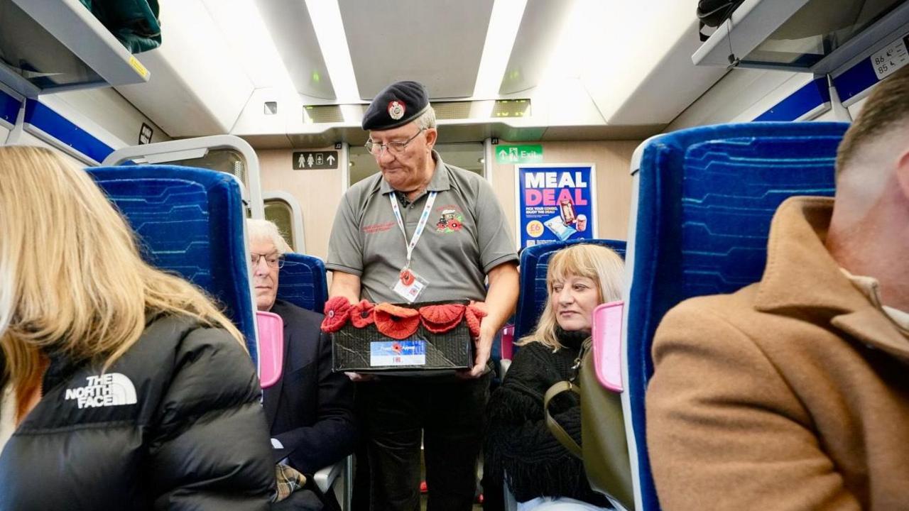 Mr Scaife selling poppies on a train