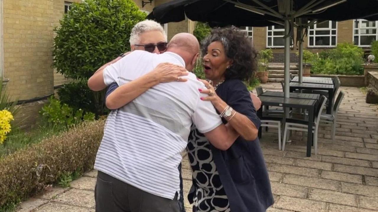 The half-siblings embrace moments after meeting for the first time