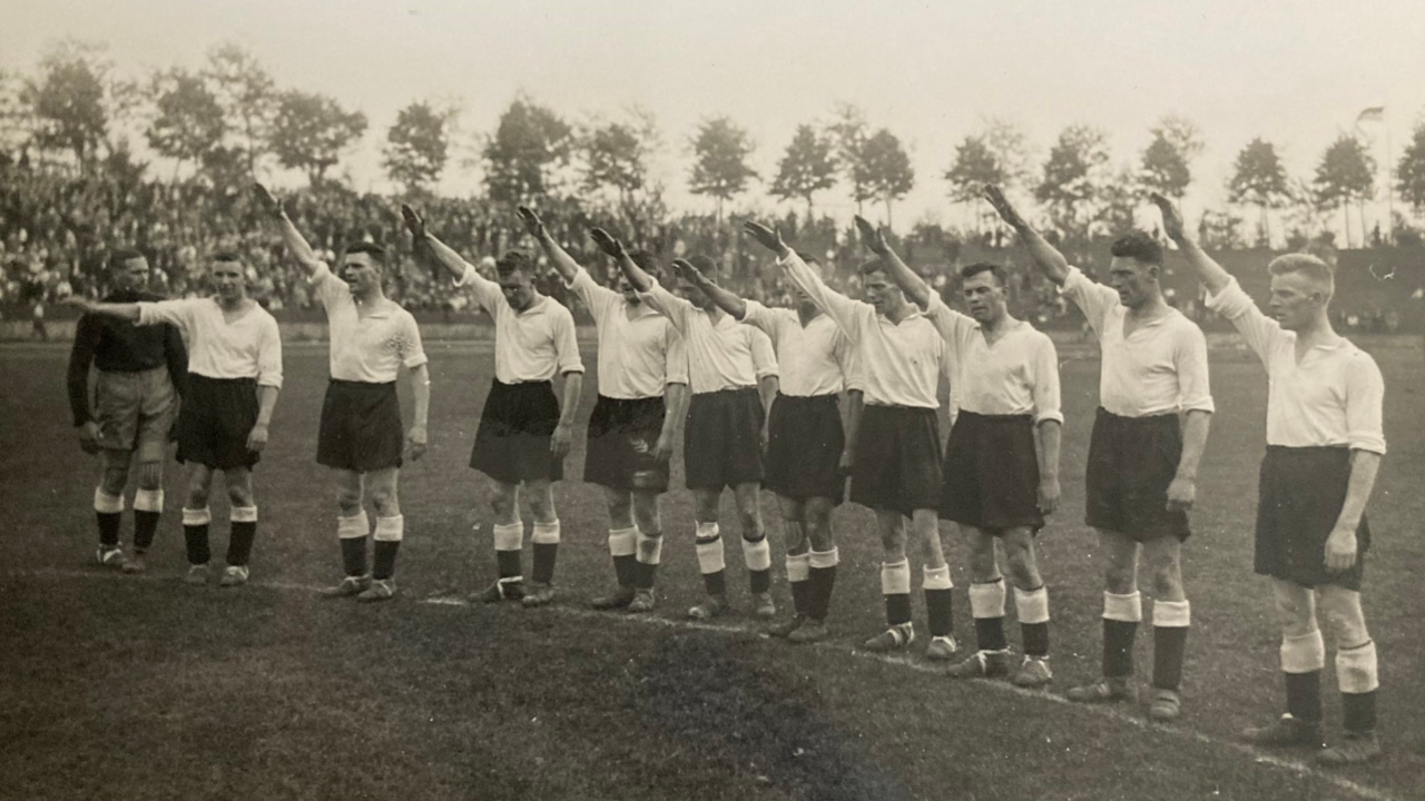 A group of Derby County players performing a Nazi salute on a football pitch in Germany in 1934