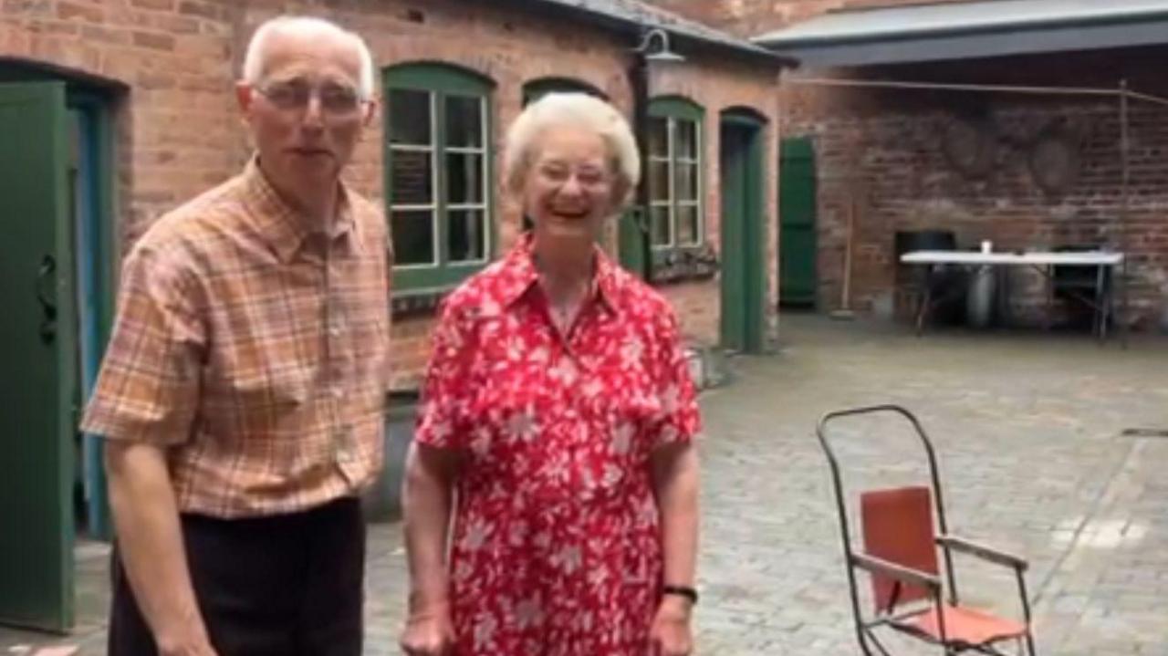 Les Millington and wife Margaret standing in the courtyard at Birmingham Back to Backs