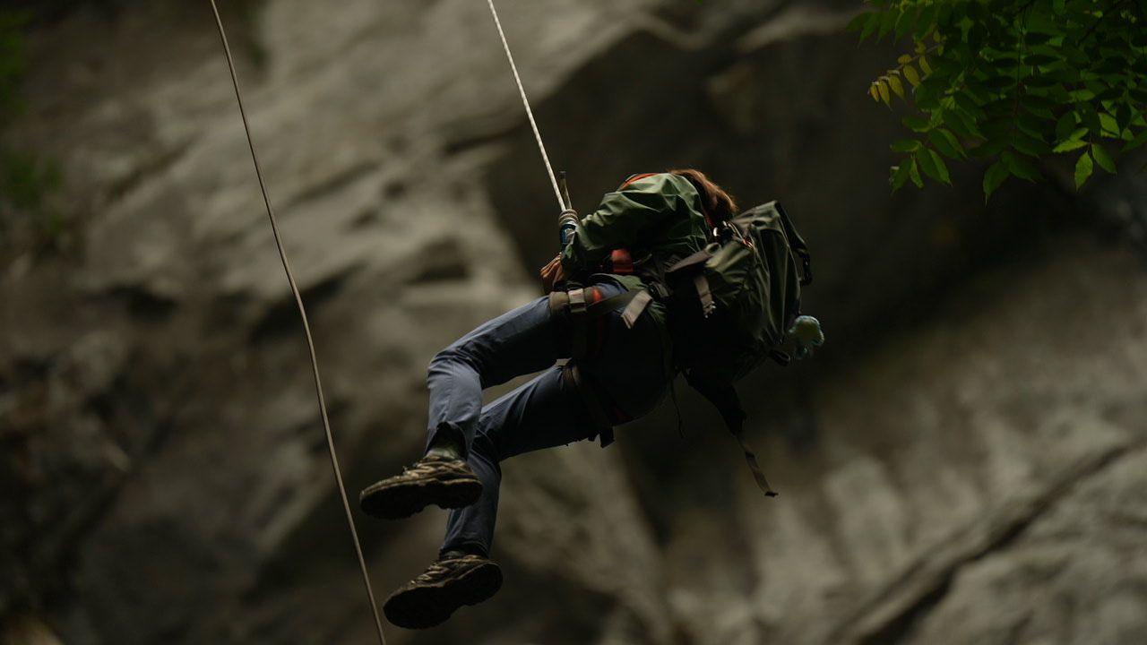 A person is lowered into a sinkhole