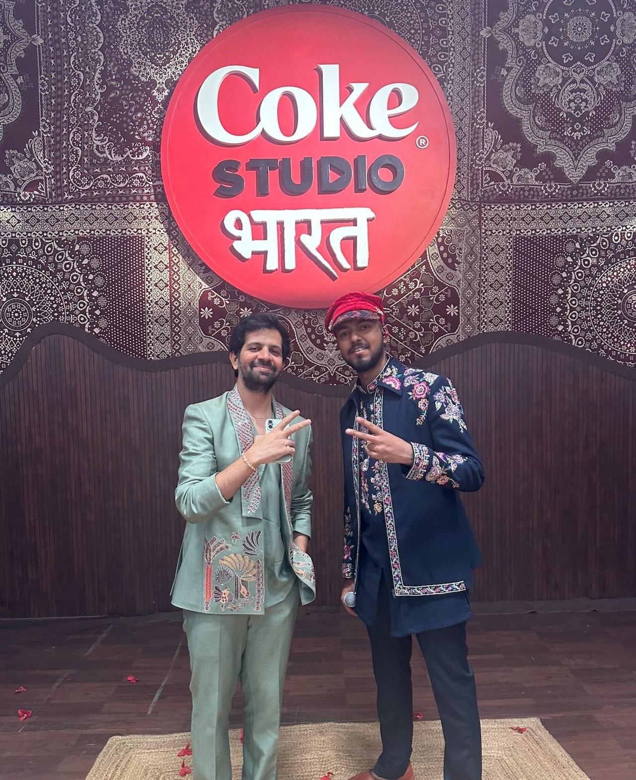Khwaab and Utpal Udit pose in front of a Coke Studio Bharat logo
