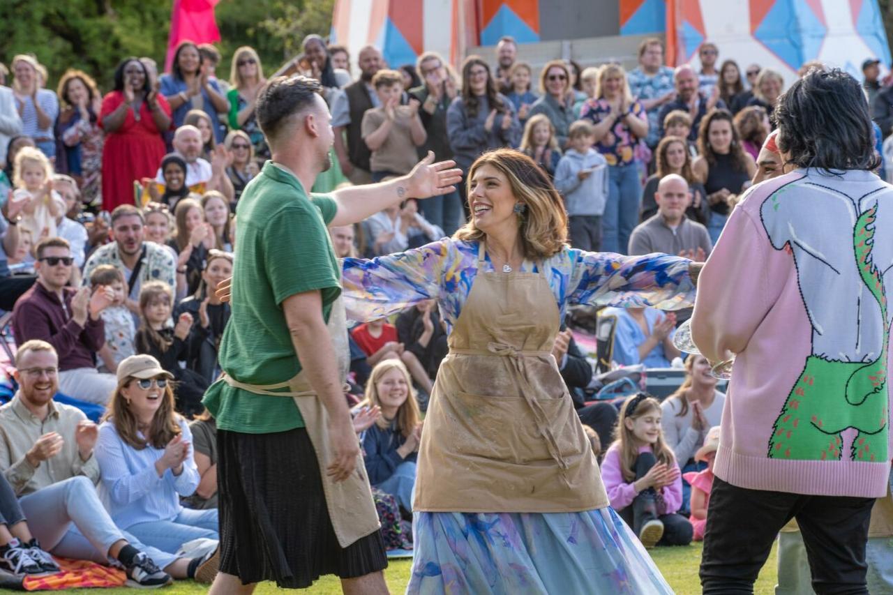 Great British Bake Off contestants congratulating winner. 