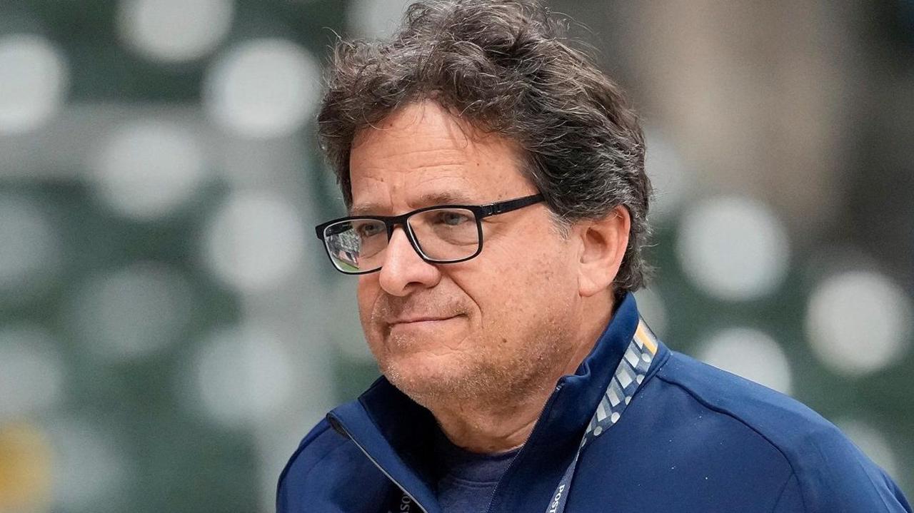 Mark Attanasio at a Milwaukee Brewers v Chicago Cubs baseball game earlier this month. He has thick dark-coloured hair, black-framed glasses, and is wearing a blue fleece.