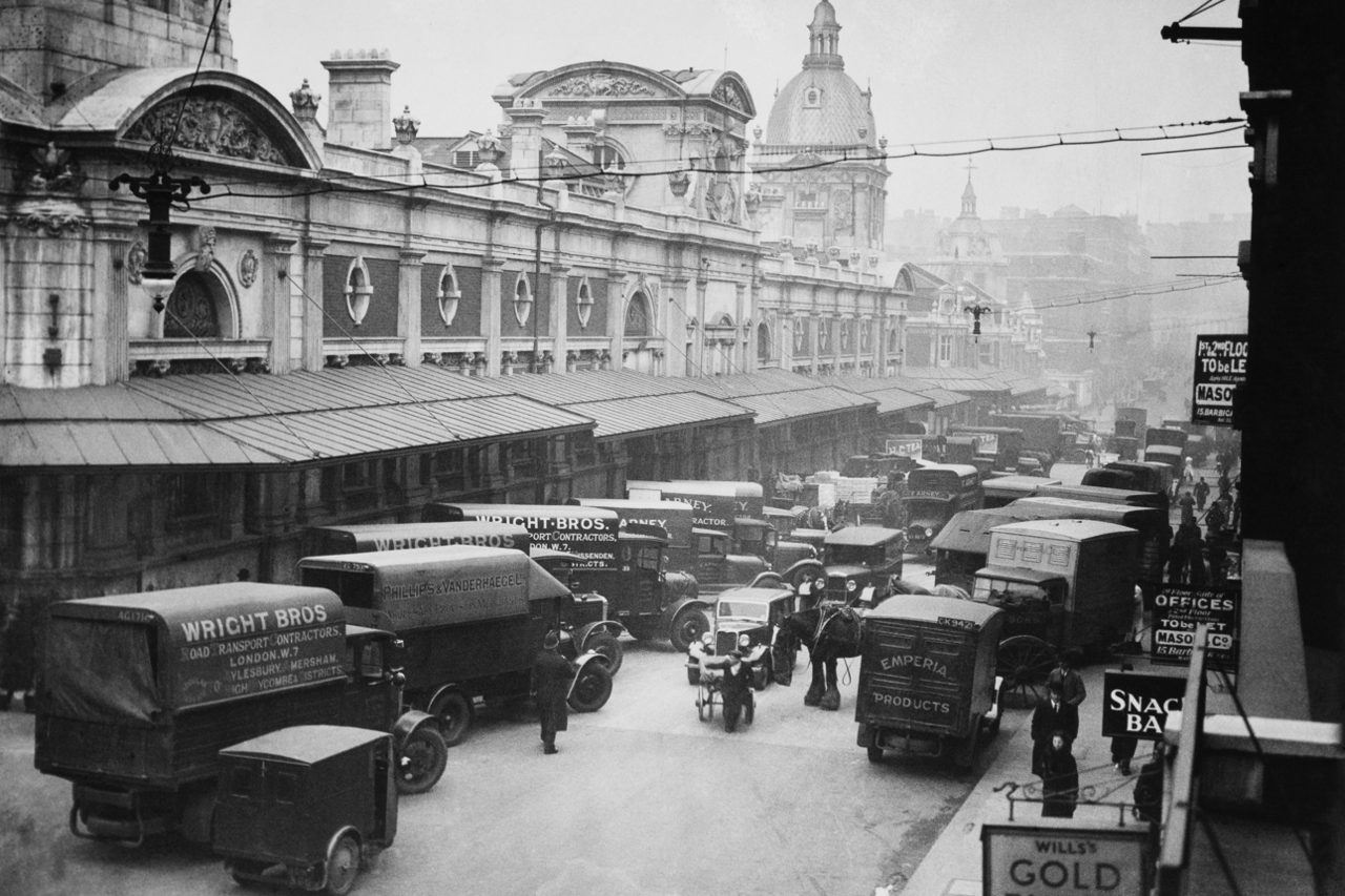 Black and and white image of meat vans lined up on road outside Smithfield Market