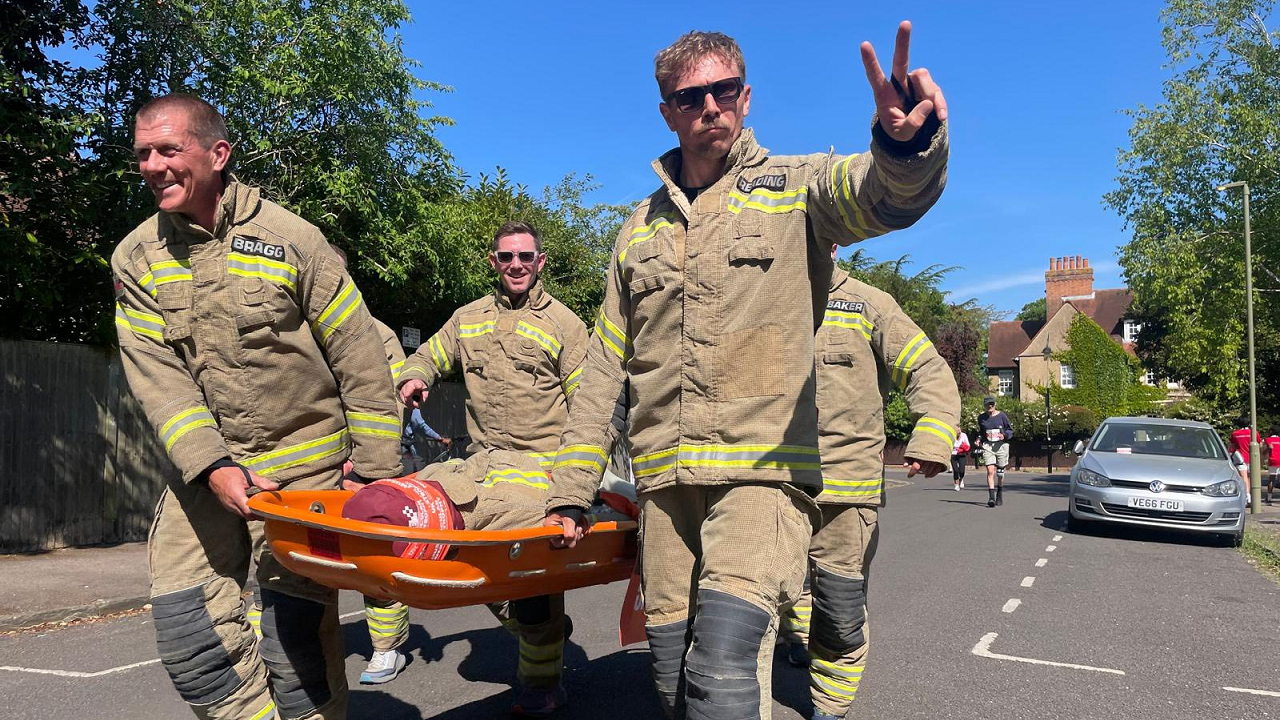 Firefighters carrying the mannequin on a stretcher through a North Oxford street.