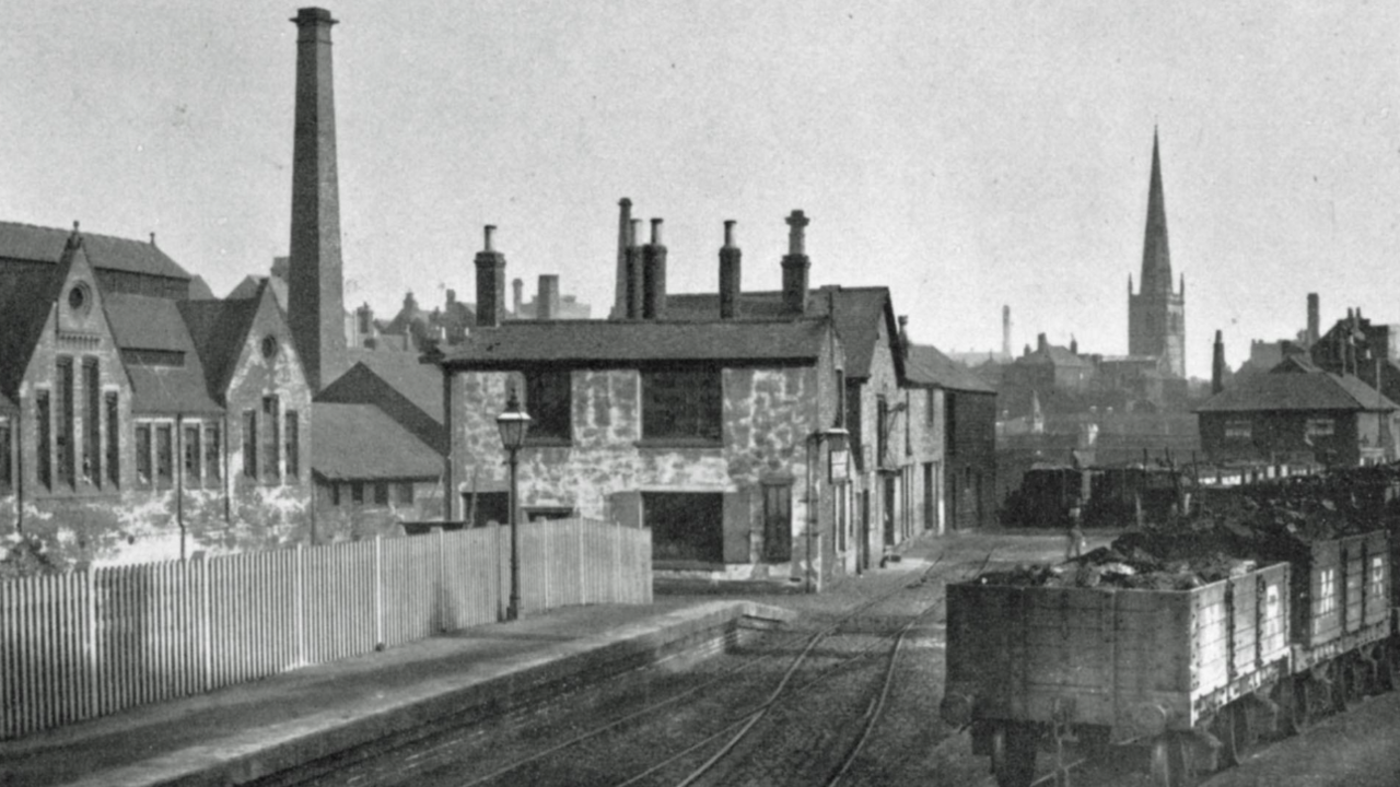 A black and white image of the West Bridge station before it was demolished with St Mary De Castro's church spire behind