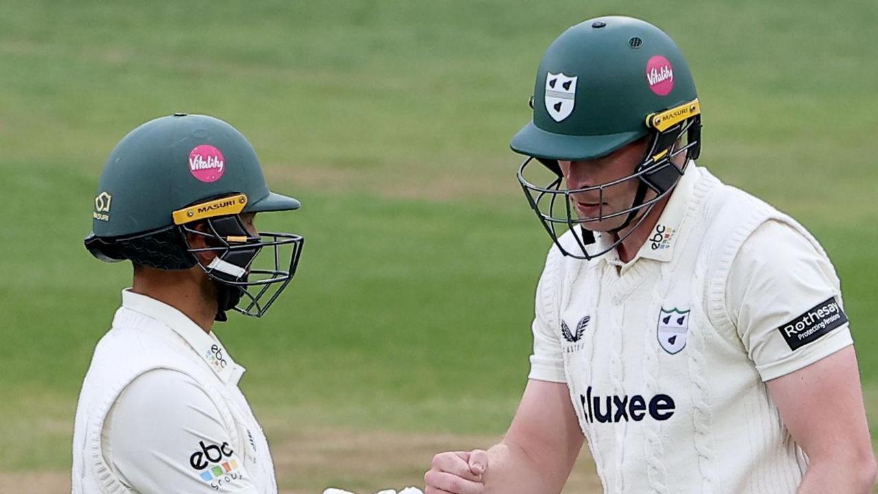 Matthew Waite punches fists with Brett D'Oliveira while batting for Worcestershire