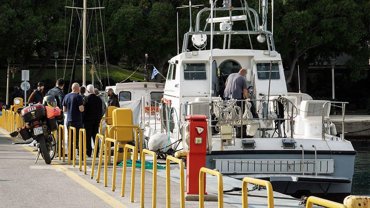 Paramedics and coast guard officers transfer the bodies of migrants following a collision off the island of Rhodes, Greece