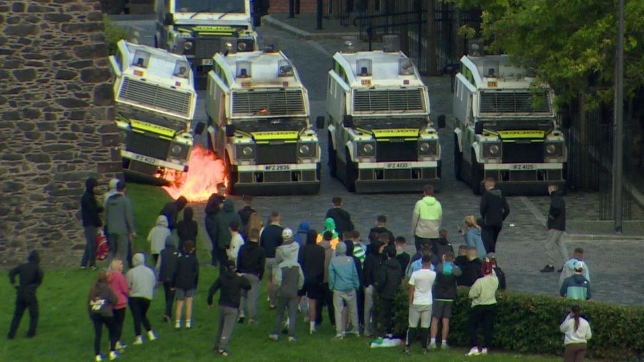 Trouble in Londonderry showing five land rovers, one with a fire after a petrol bomb was thrown