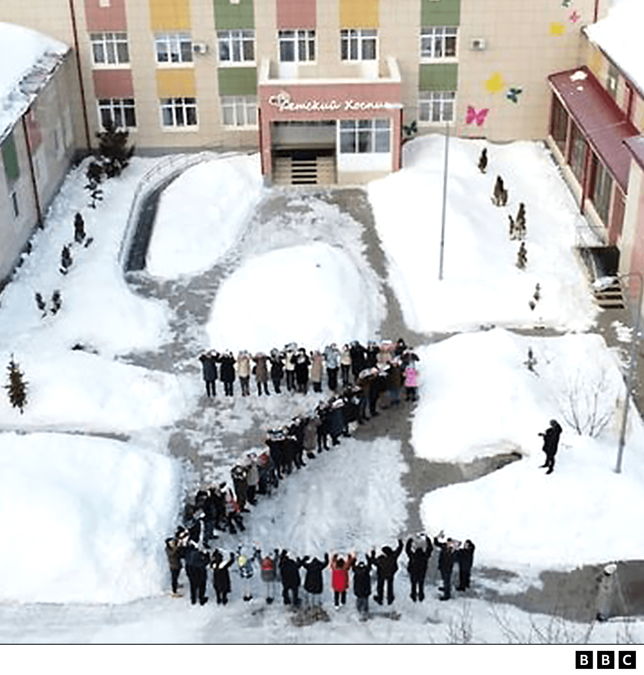 Children and staff at a hospice spelling out "Z" in the open air