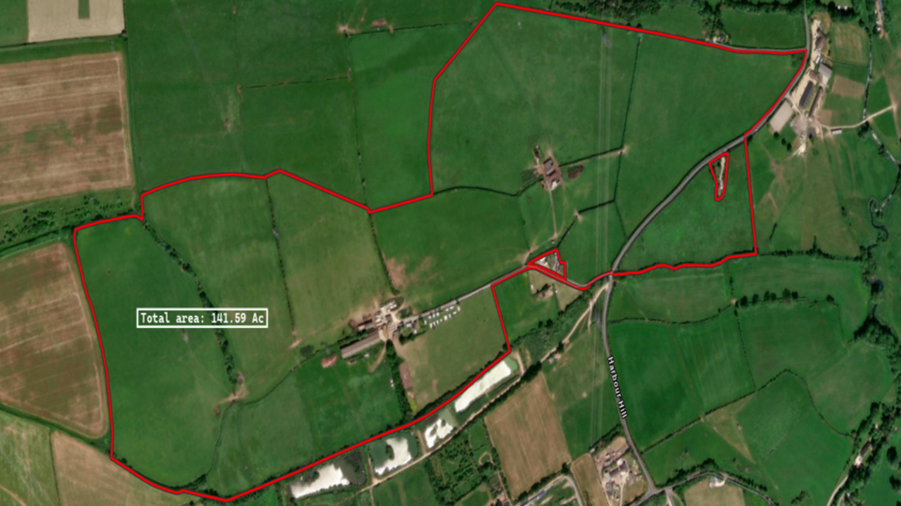 A Google Earth aerial photography map showing the proposed site which is marked with a red line. The entire area is covered in green farm fields with a campsite in the centre.