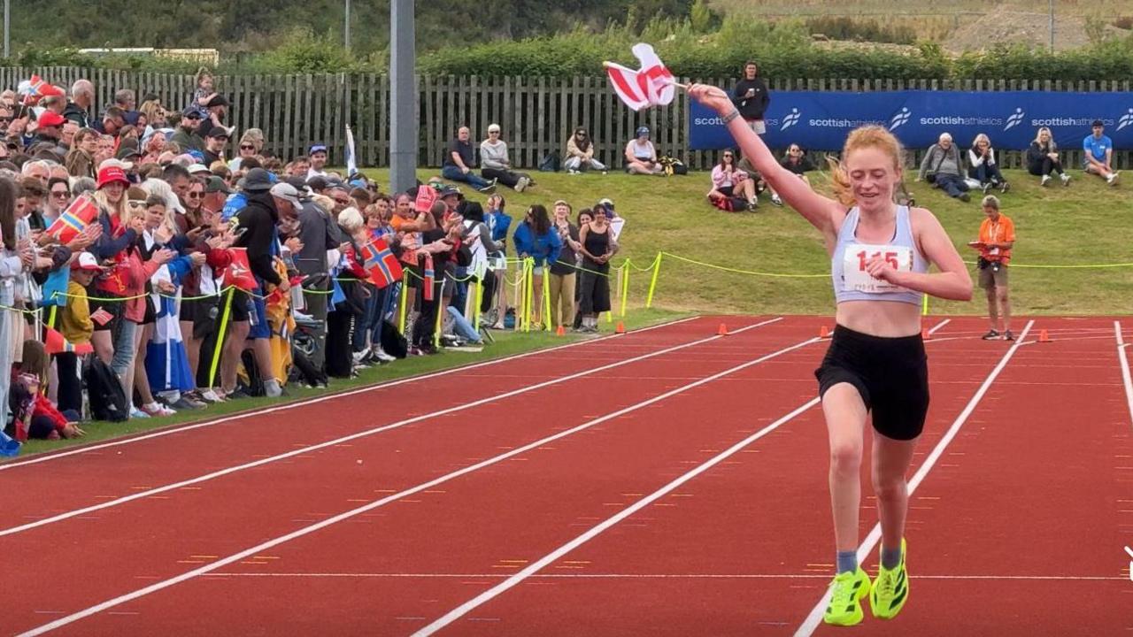 Jess Troy receives the adulation of the crowd as she crosses the finishing line in Kirkwall