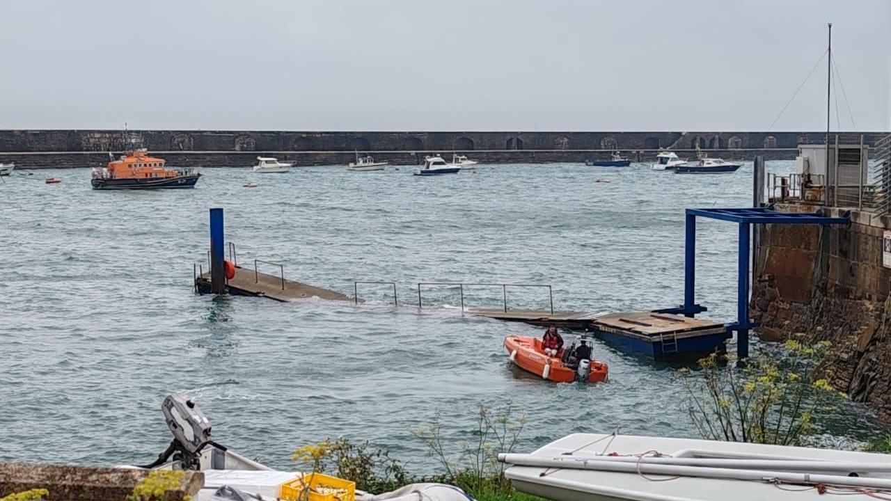 A view of the harbour with the middle of the pontoon underwater 