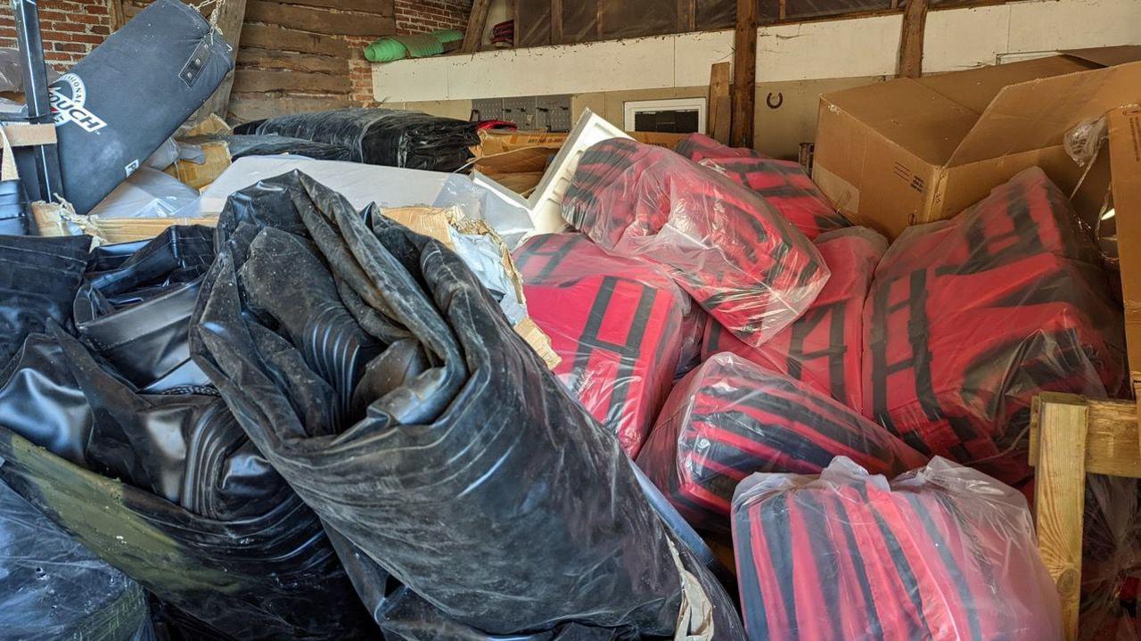 Dinghies and life jackets piled high in a storage unit in Osnabruck, Germany