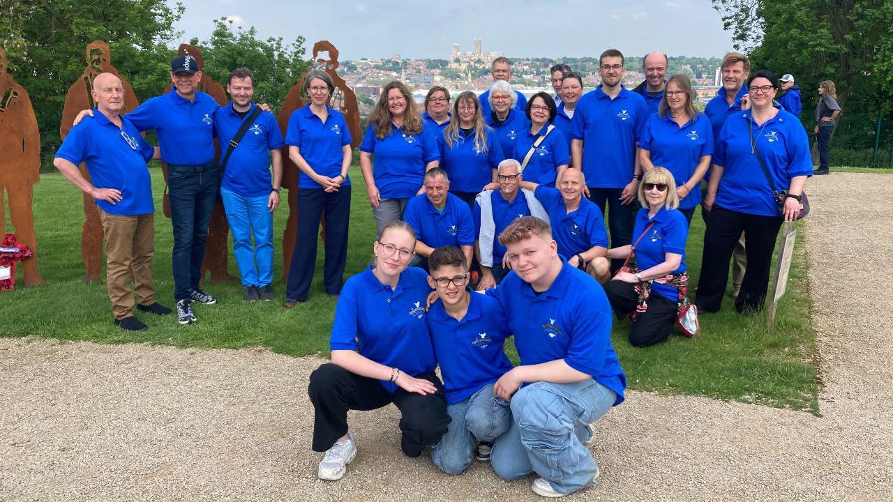 A group of people wearing blue t-shirts