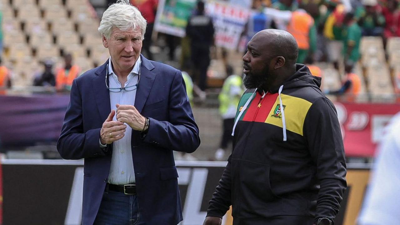 Cameroon coach Marc Brys (left) in conversation with an assistant coach