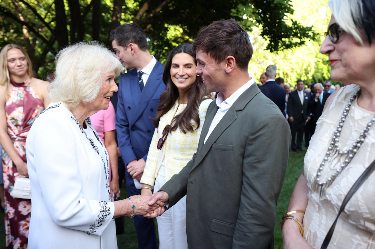 Queen Camilla shakes hands with British Olympic diver Tom Daley 