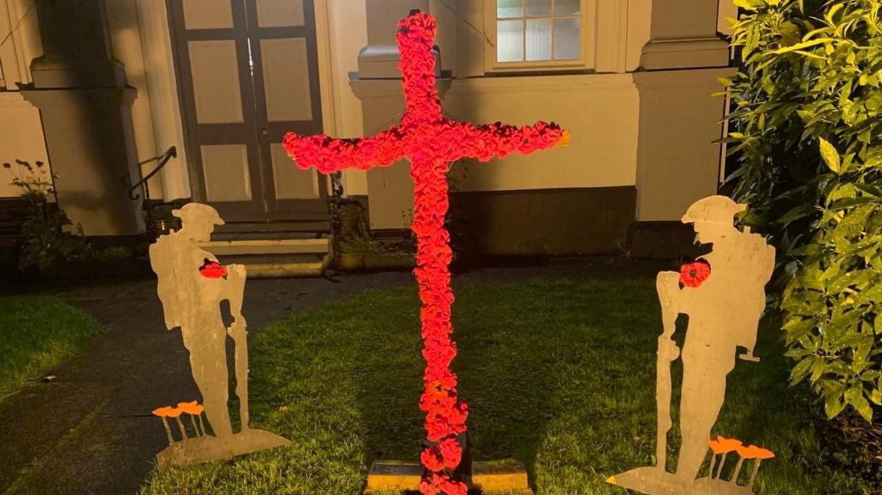 A cross covered in poppies