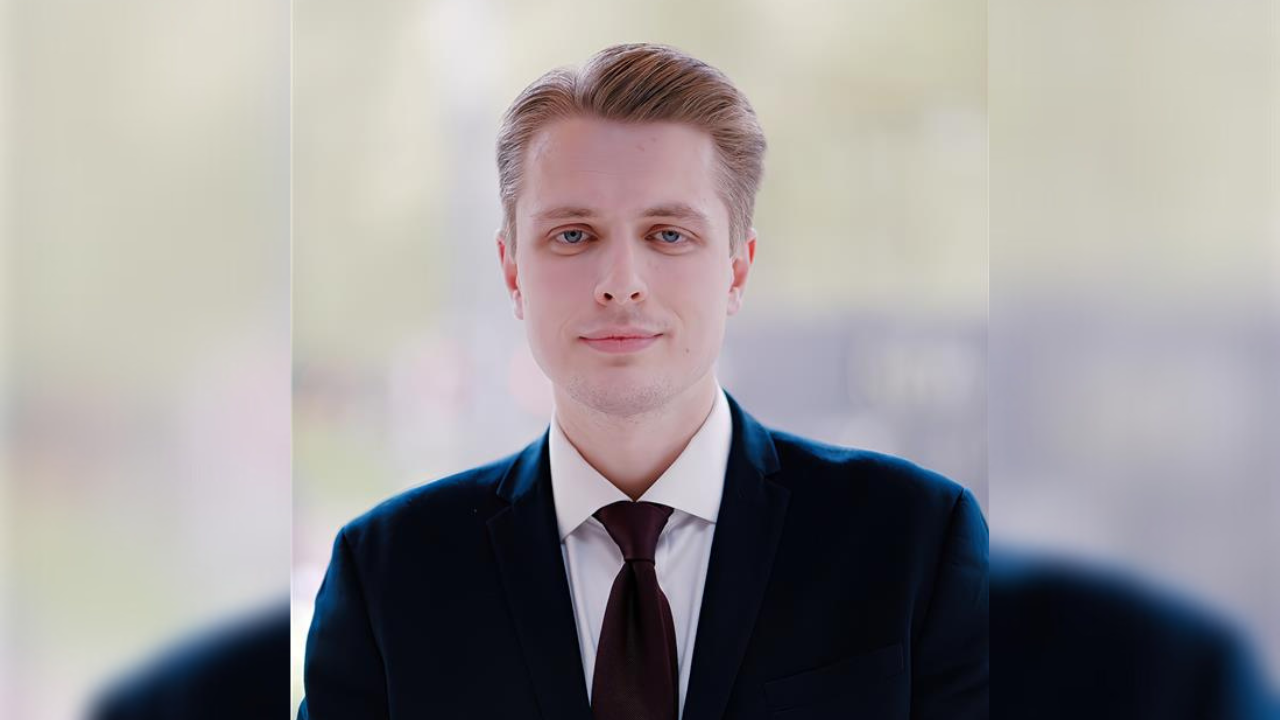 Superintendent Daniel Thompson from the Met Police wearing a black suit and shirt and tie