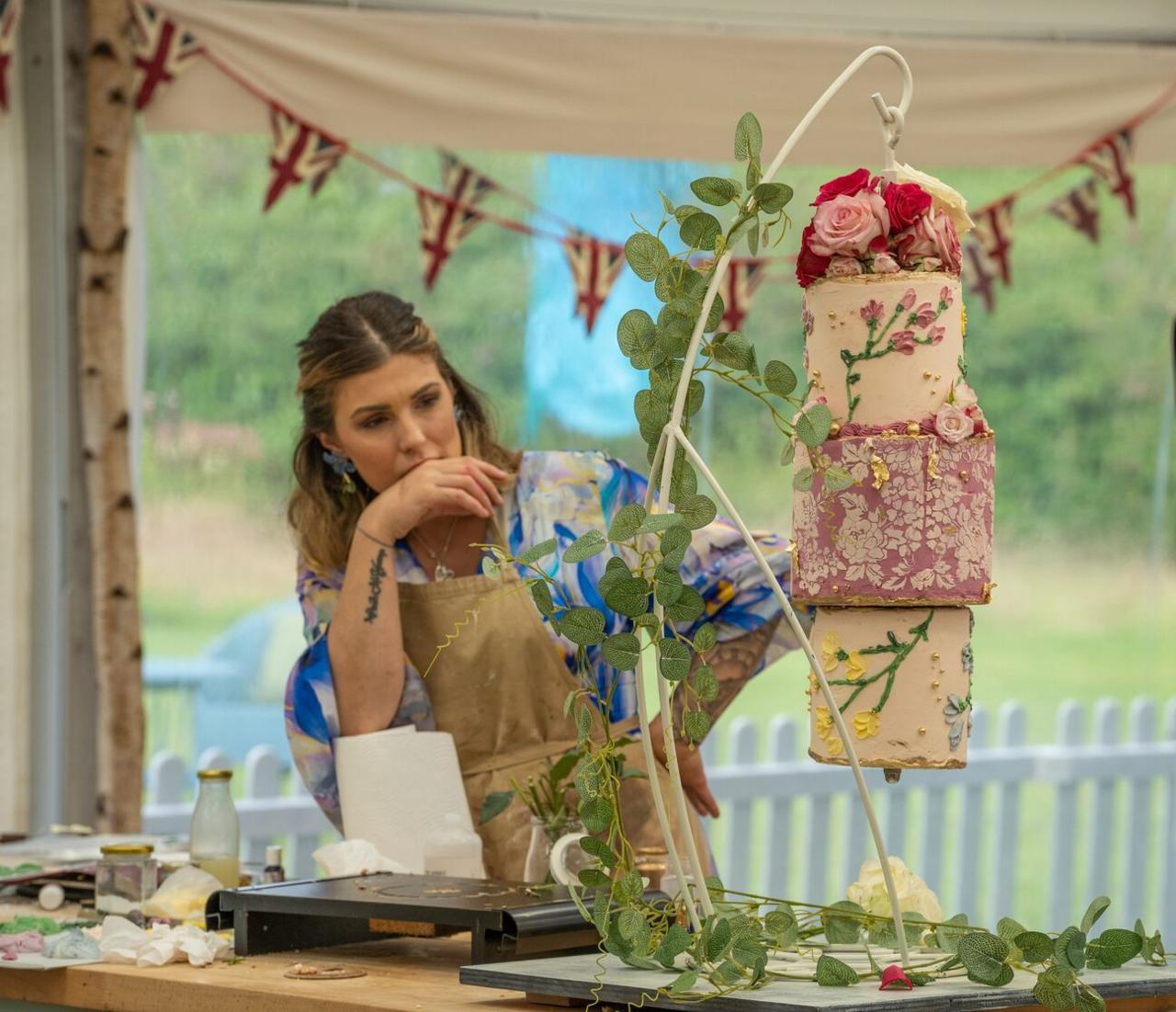 Georgie from series 15 of the Great British Bake Off with her cake. 