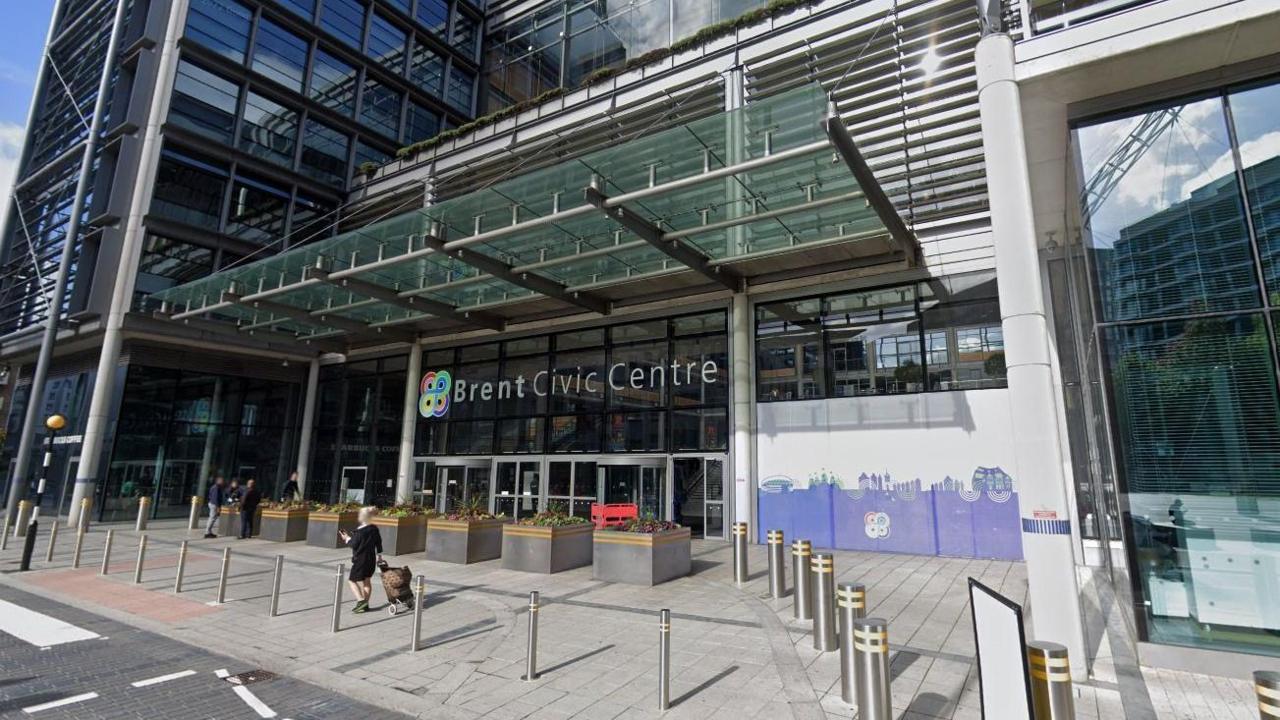 The exterior of the Brent Civic Centre building. It is a modern-looking building, with a glass facade.