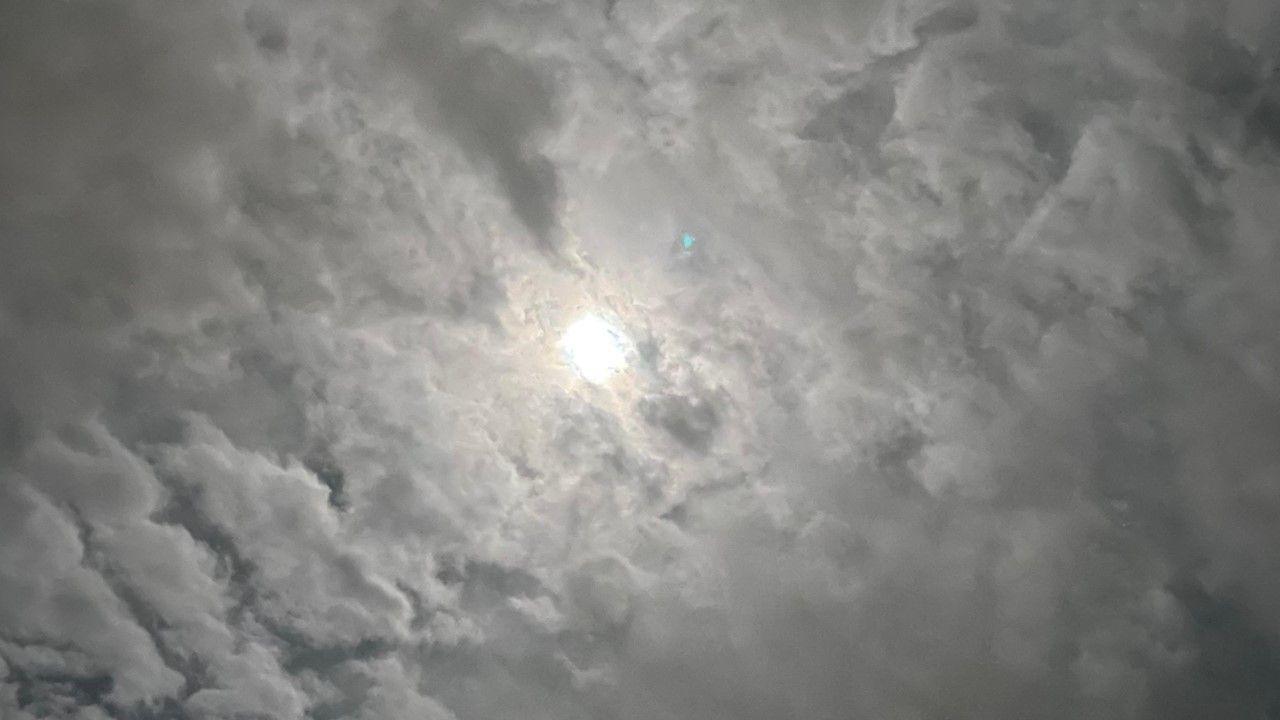 High level cloud obscuring a full Moon 