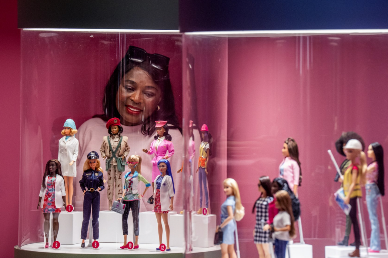 A woman takes a closer look at some of the Barbie dolls on display during a preview of in Barbie: The Exhibition at Kelvingrove Art Gallery and Museum in Glasgow