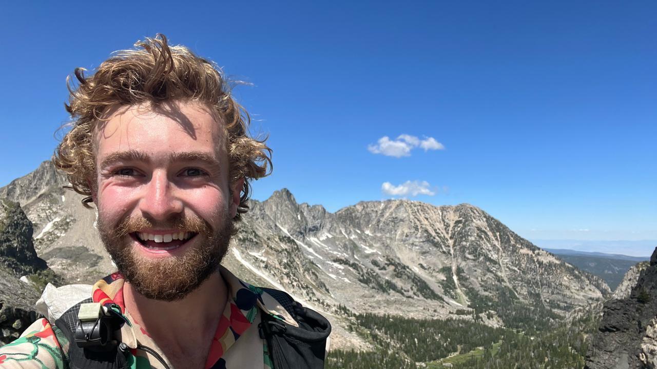 Piers Ellison, in front of a mountain range