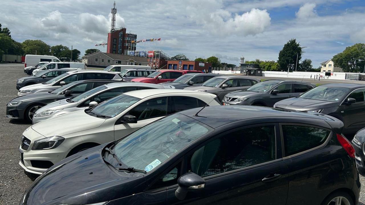 Cars parked in the paddock area near the TT grandstand in Noble's Park