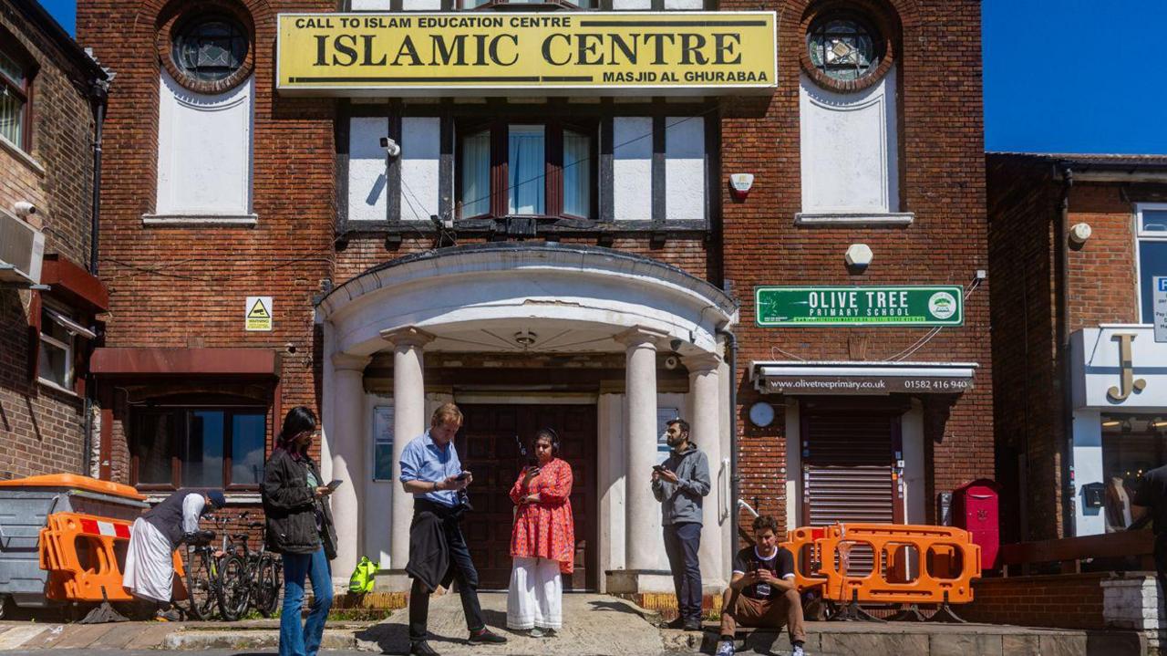 People listening to an audio tour of Bury Park in Luton