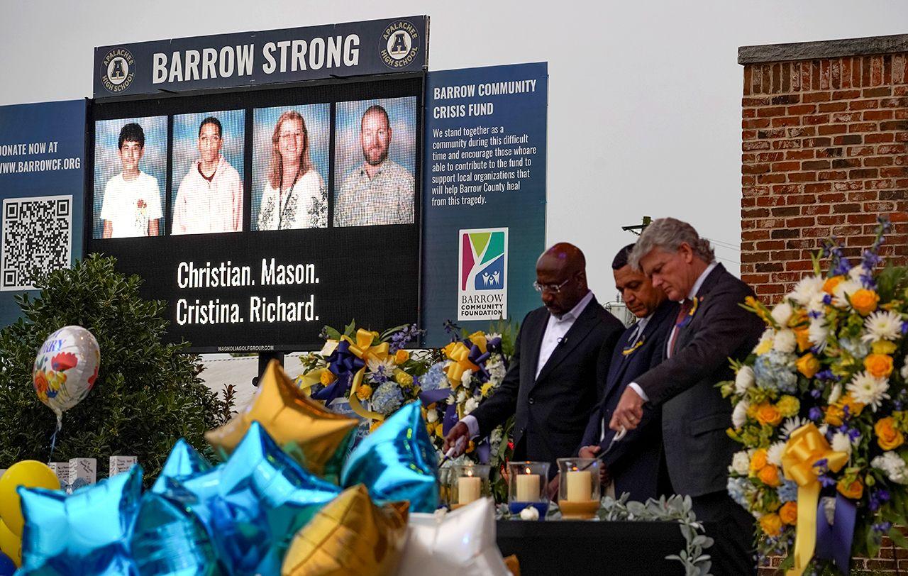 Photos of the victims of the Apalachee High School shooting are displayed on a screen during a vigil at Jug Tavern Park in Winder, with politicians lighting candles in the foreground, in Georgia, U.S. September 6, 2024