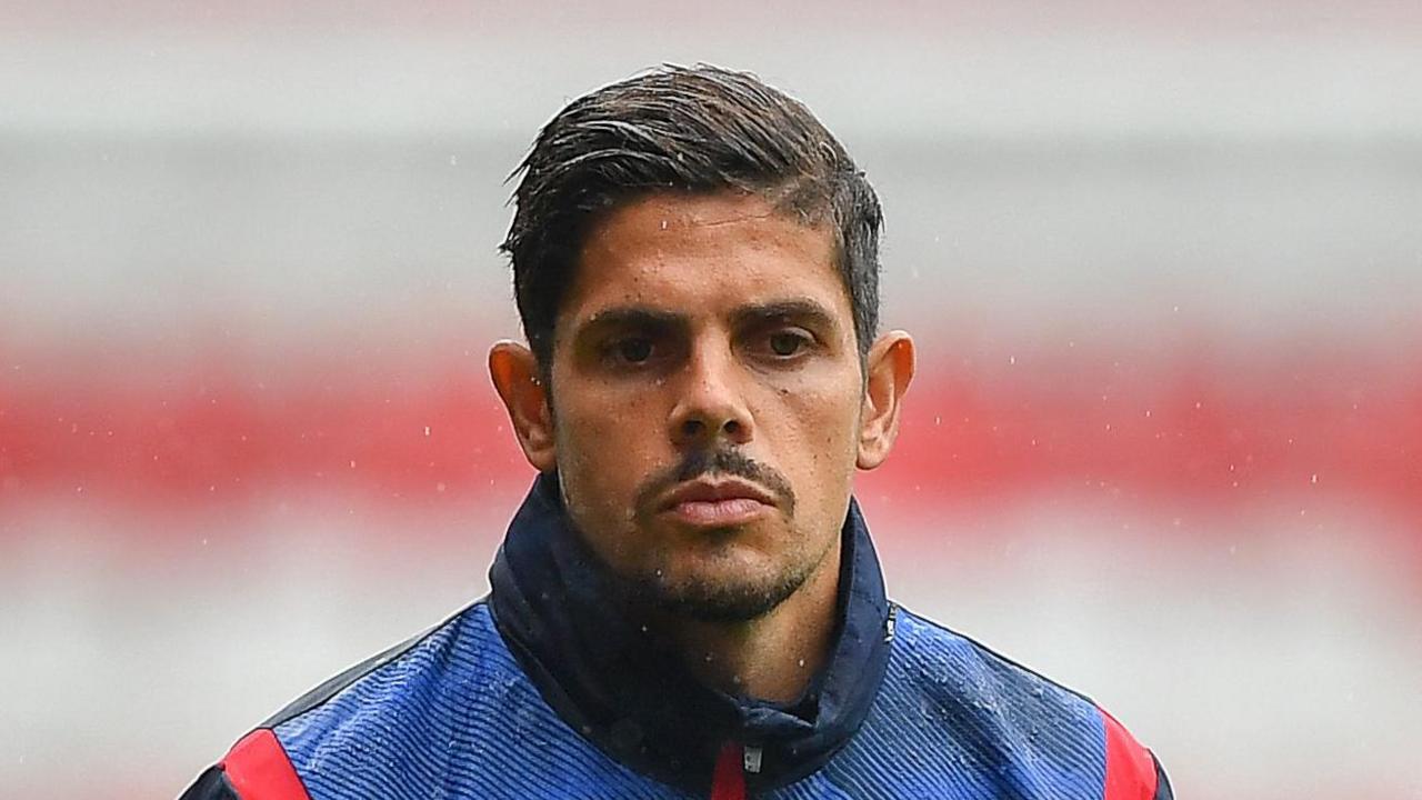A close-up of Guilherme Ramos standing in the rain while he was assistant manager at Nottingham Forest