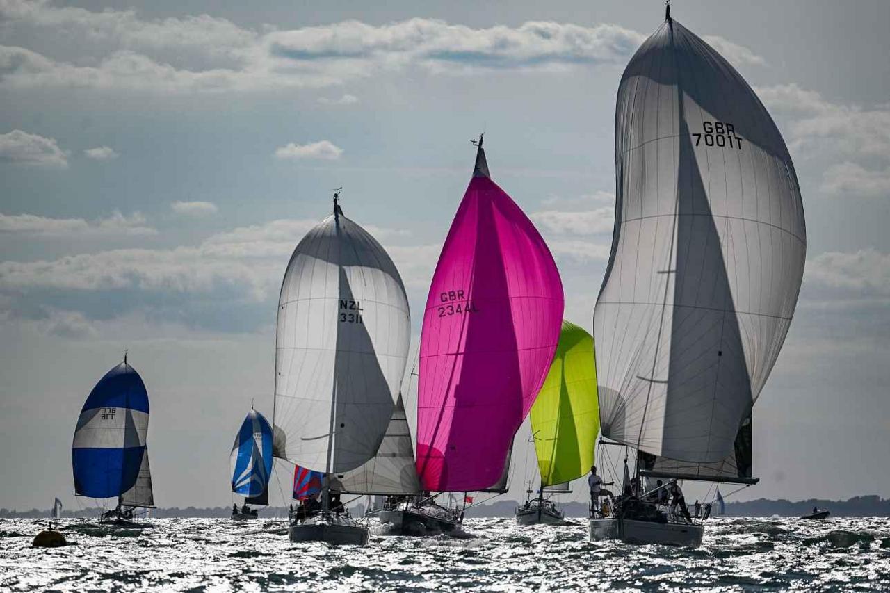 A group of yachts on the sea with different coloured billowing sails. They include Challenger, Nimbus, Salt.