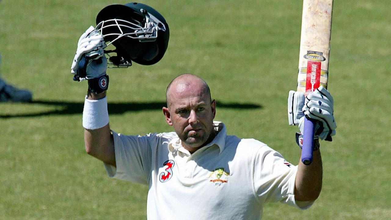 Australia batter Darren Lehmann acknowledges applause after completing a Test century against Bangladesh in Darwin in 2003