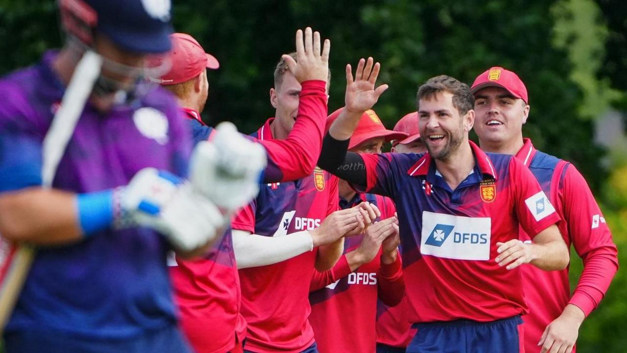Jersey captain Charles Perchard celebrates taking a Scotland wicket
