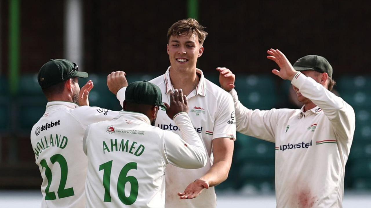 Josh Hull is congratulated by Leicestershire team-mates