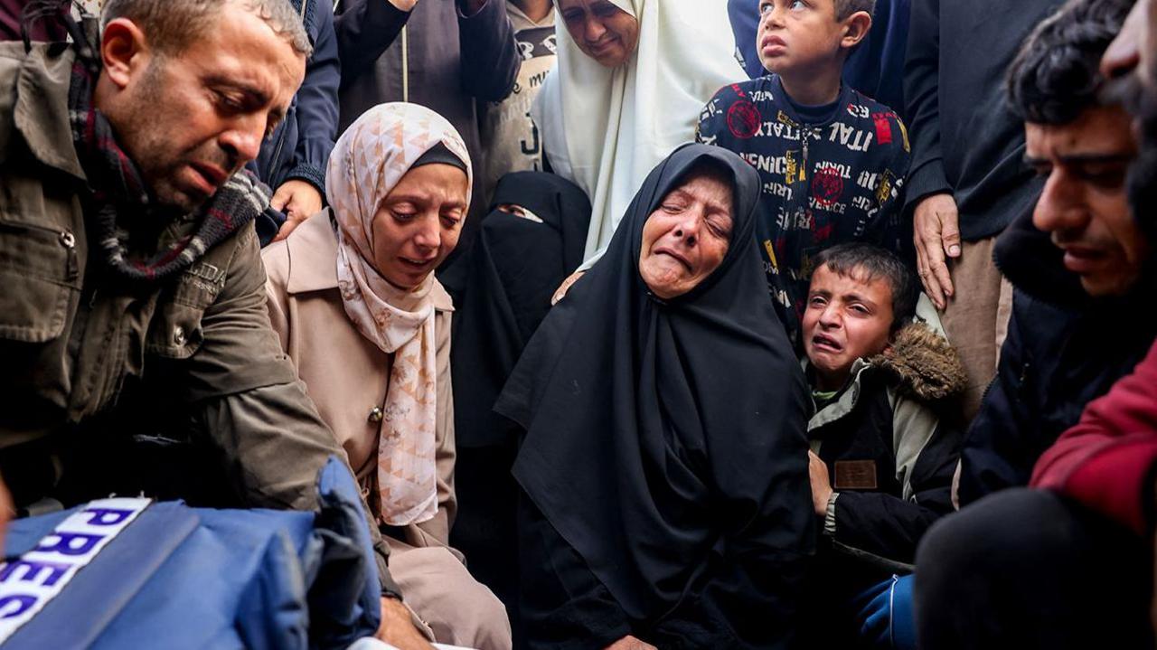 A group mourn the death of  journalist Ahmad Al-Shayah killed overnight in Khan Younis. 