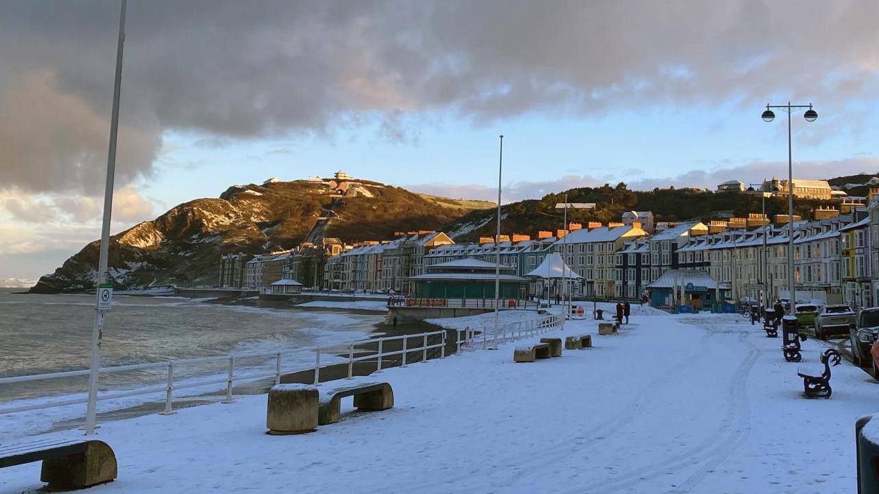 Snow on the ground on Aberystwyth promenade and beach