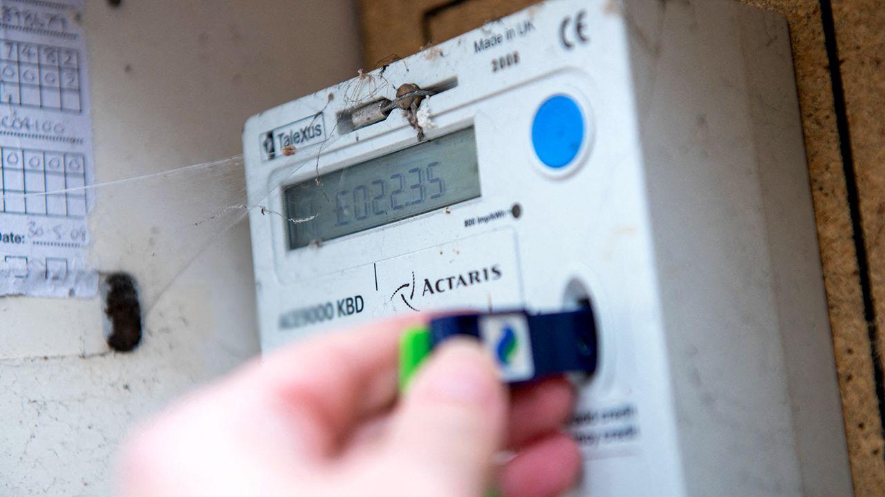 Close up of a persons hand inserting a card into a prepayment energy meter in the United Kingdom, picture taken February 2023.