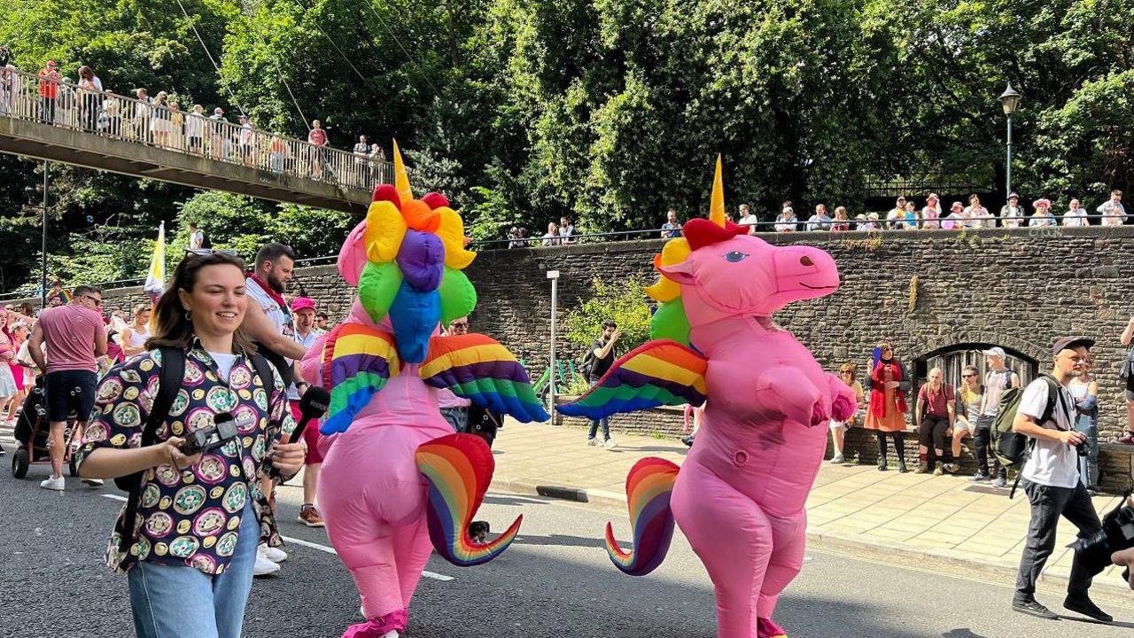 Pink inflatable unicorns taking part in Bristol Pride's parade.