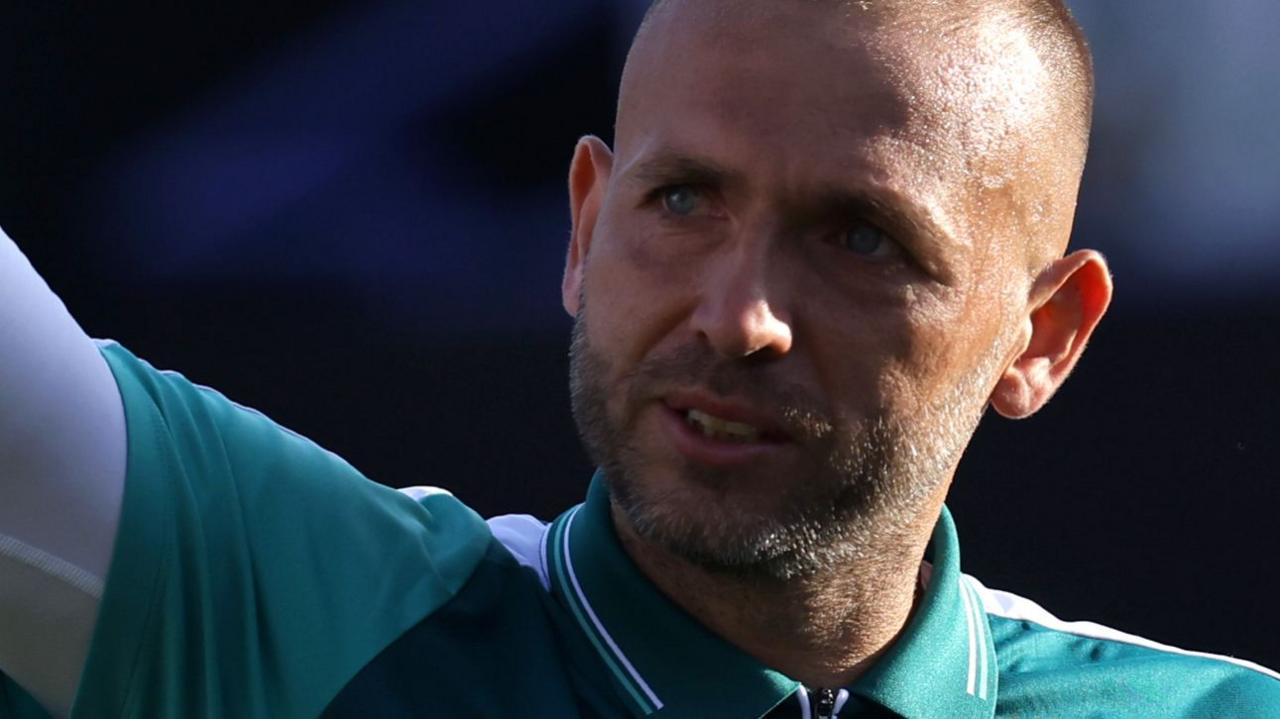 Dan Evans waves at supporters during Eastbourne
