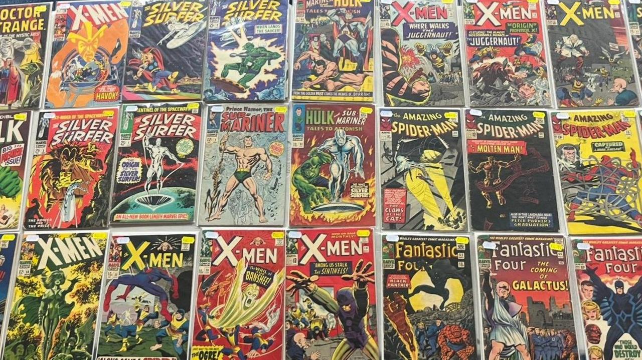 Three rows of comic books, each with colourful designs. There are X-Men, Hulk, Silver Surfer and Fantastic Four titles among them.