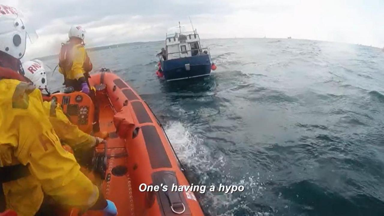 The RNLI crew from Plymouth approach the boat