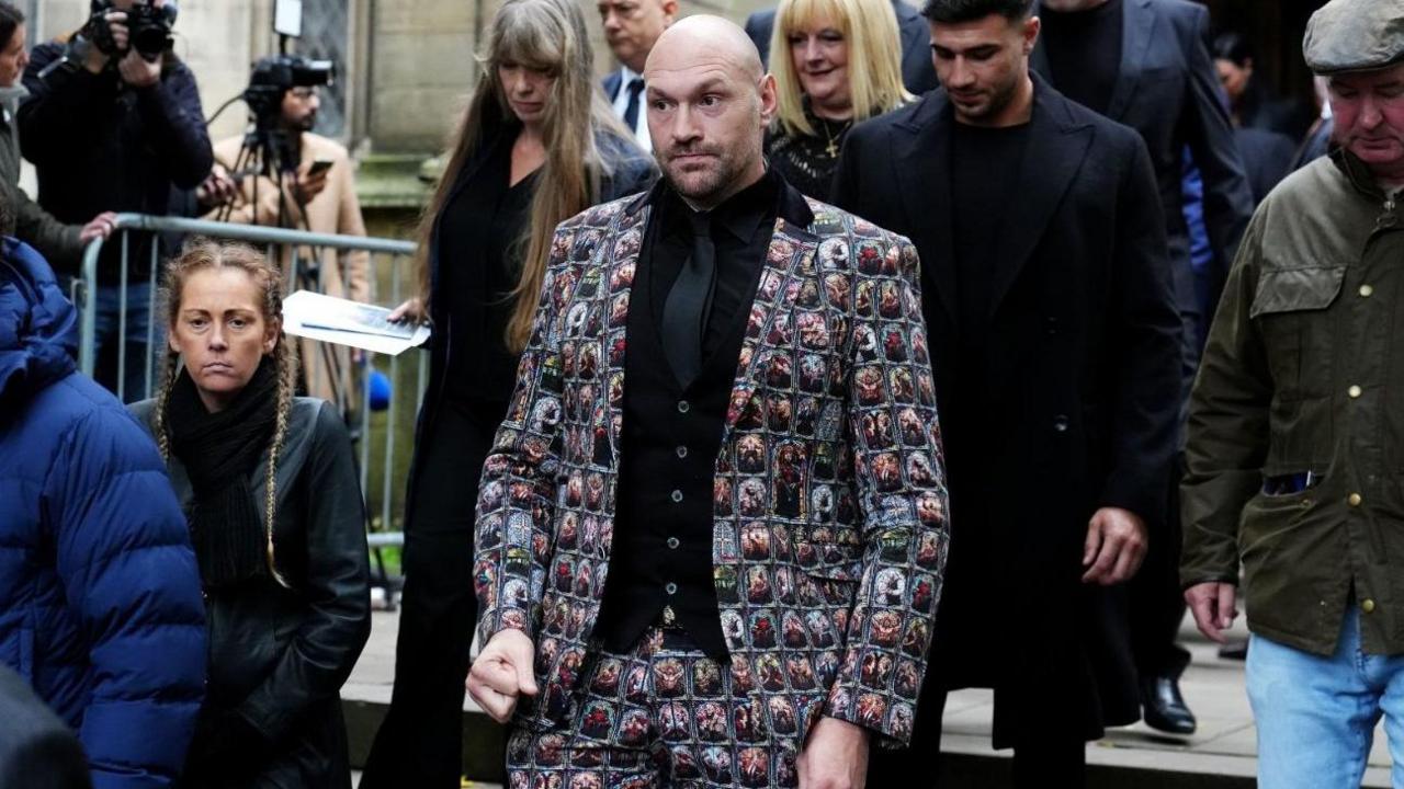 Tyson Fury is walking out of the funeral service for Ricky Hatton at Manchester Cathedral. His brother Tommy is walking behind him.