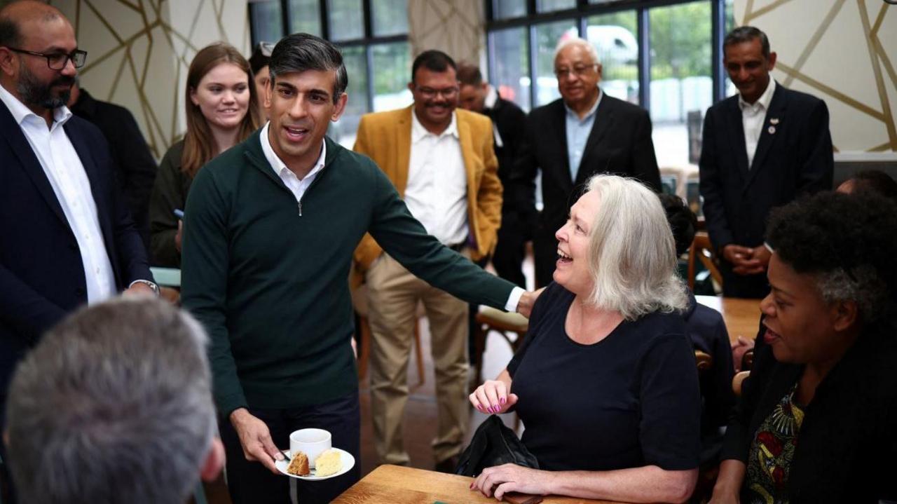 The prime minister chats with members of the public at a garden centre in Crawley