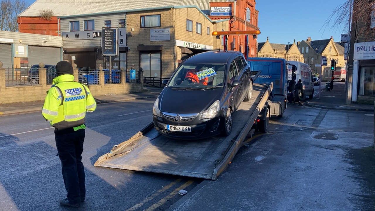 A car is loaded on to a lorry to be towed away