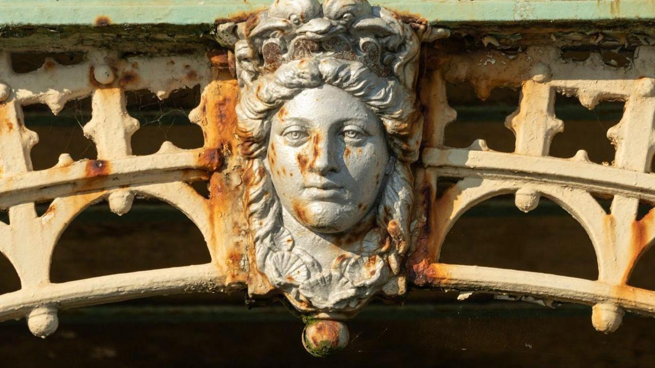 Madeira Terrace’s decorative ironwork featuring marine-inspired details including the face of Aphrodite as keystones of the arches